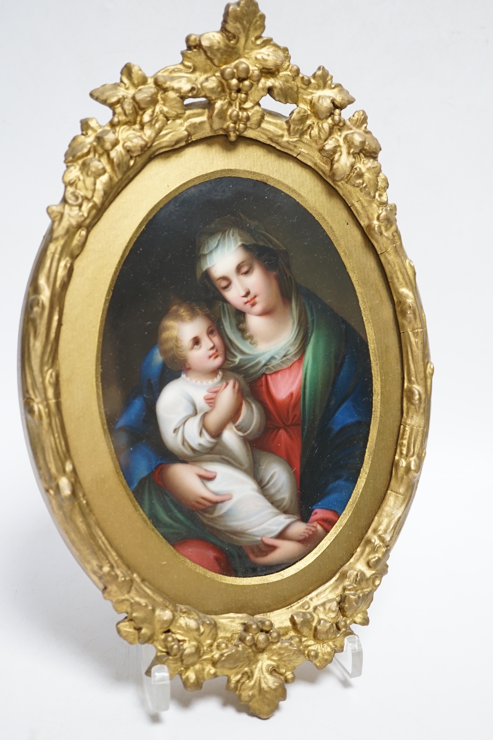 A 19th century Paris porcelain plaque depicting the Virgin Mother and child in a gilt painted frame, 16cm high